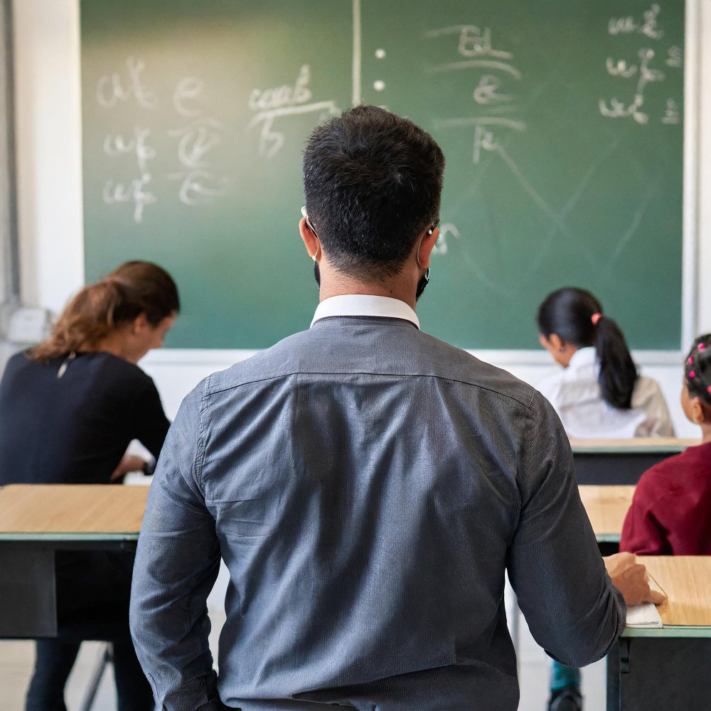 Teacher guiding students in a classroom